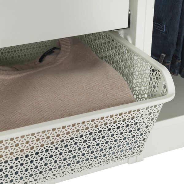 White wardrobe with patterned metal basket storing folded beige clothes.