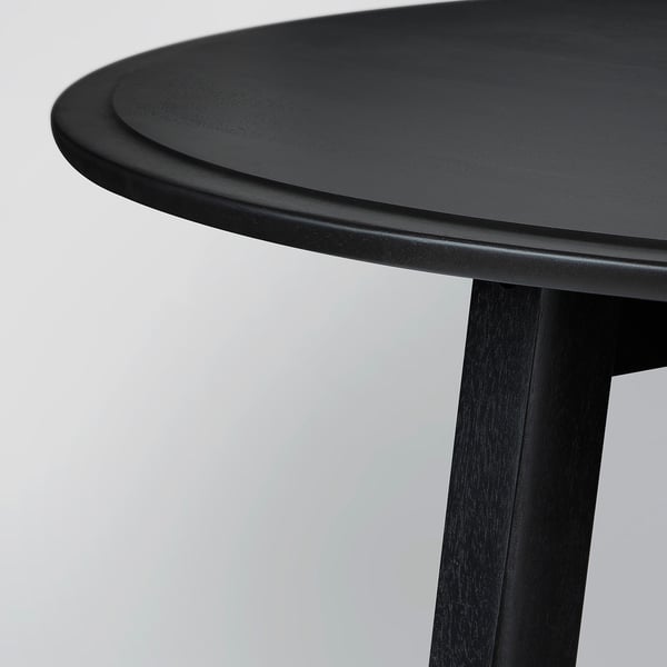 Image shows a stylish black KRAGSTA coffee table with smooth edges and solid mango wood construction.