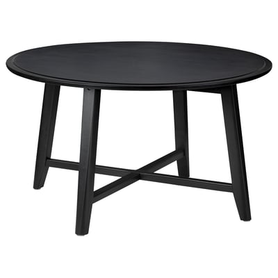 Black round KRAGSTA table, solid mango wood, four angled legs.