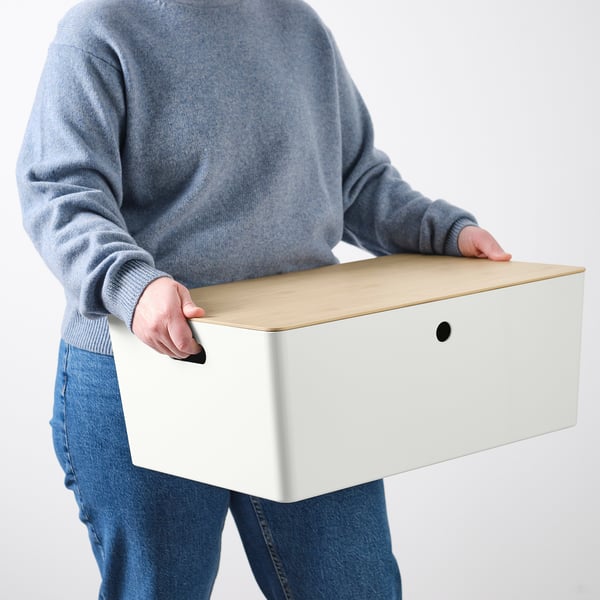 Person holding a white KUGGIS box with a lid, suitable for dust protection and stacking, made from bamboo.