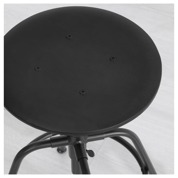 Black round stool with a metal base and adjustable height, shown from beneath.
