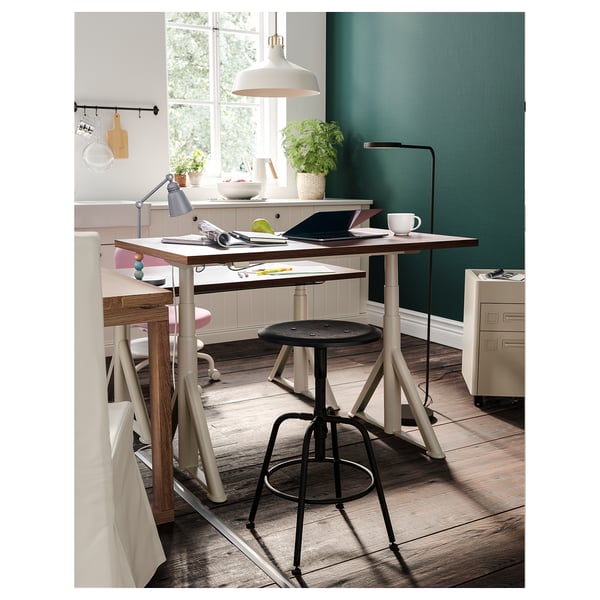 Modern office space with KULLABERG stools, wooden desks, pendant lights, and plants.