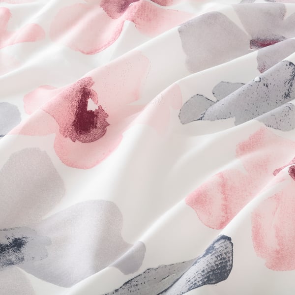 Abstract floral bedding with soft pink and grey hues, crisp weave, and complex textures. Sheets appear smooth and high-quality.