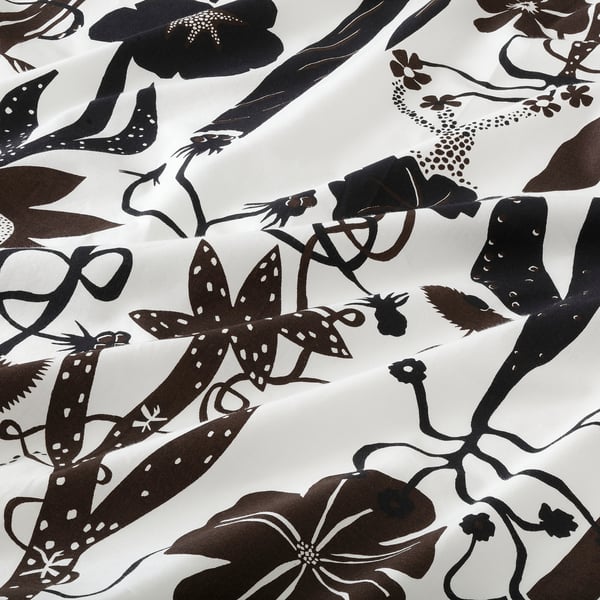 Black and white floral bedding on display, showcasing intricate patterns and soft fabric texture.