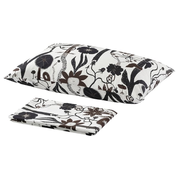 A set of white bedding with black floral patterns. It includes a flat sheet and pillowcases, showcasing an elegant, monochromatic design.