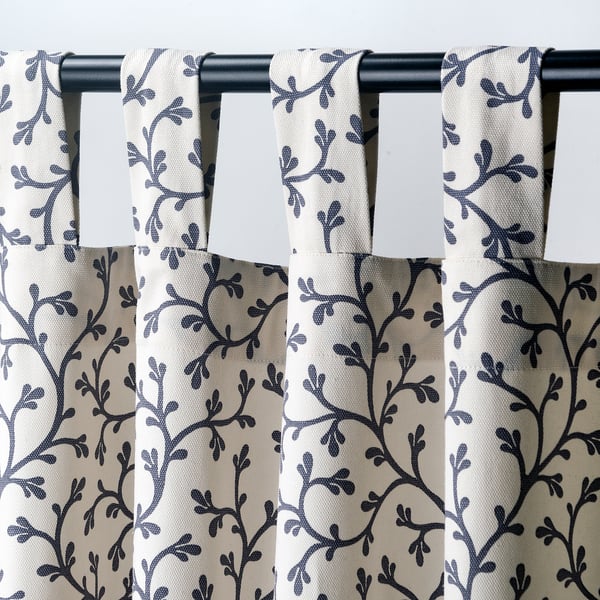 Close-up of botanical print curtains with tab headings for easy hanging.