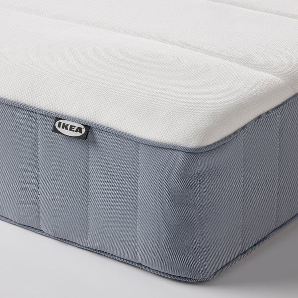 A high-quality IKEA MALM mattress displayed, featuring a soft, white textured top and grey mesh sides, emphasising comfort and durability.
