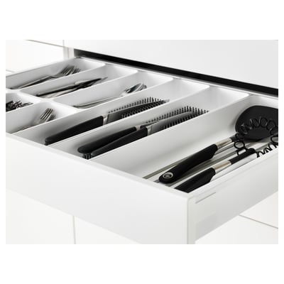 White kitchen drawer with cutlery and utensils. Soft-closing mechanism. Organised with compartments.