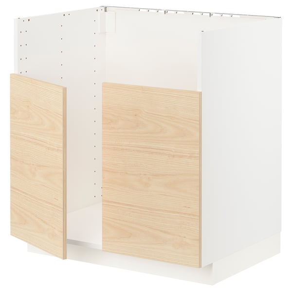 A white METOD kitchen cabinet with light ash wood-patterned doors. It has a modern design with sleek edges and snap-on hinges.