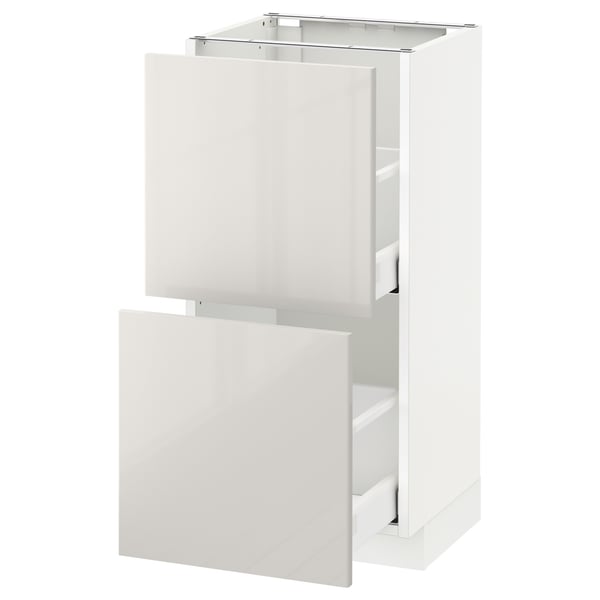 A white METOD kitchen cabinet with high-gloss, smooth surfaces and a sleek, modern design.