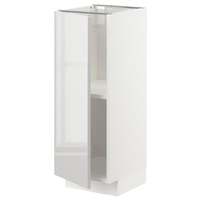 A white METOD kitchen cabinet with a glossy finish, rectangular shape, and two shelves.
