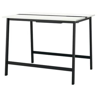 An MITTZON high conference table, white with black metal legs. Its for sitting or standing and includes a footrest for support.