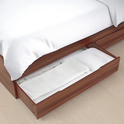 Under-bed storage, one drawer open with linens.