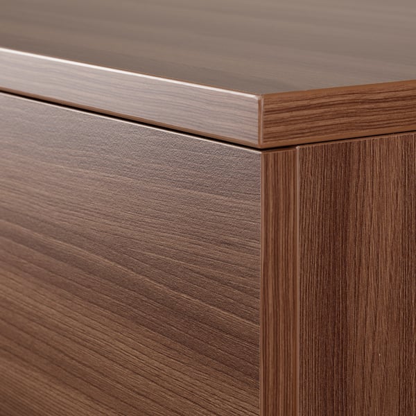 Close-up of polished wooden chest drawer edge, showcasing smooth finish and sleek design.