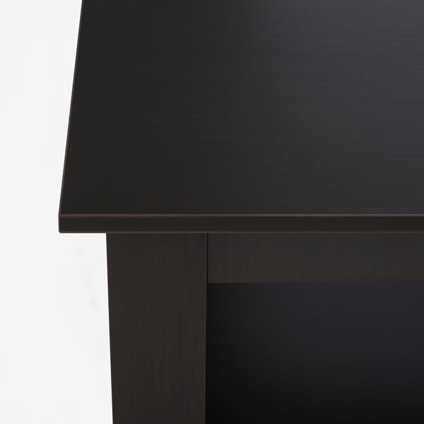 Close-up of a sleek, black coffee table with a smooth top and sturdy legs.