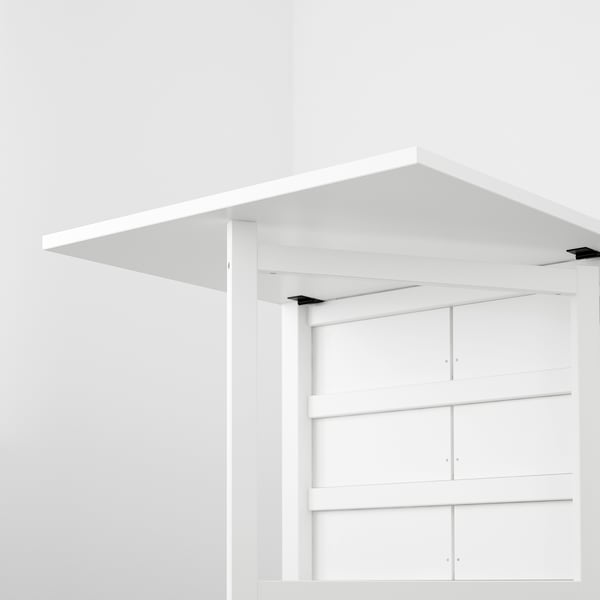 Image shows NORDENs space-saving, adjustable gateleg table with hidden drawers for storage.