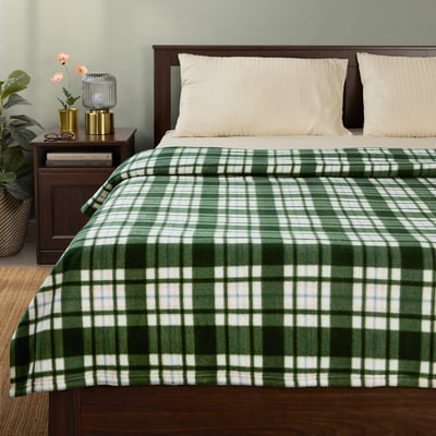 Green & white plaid blanket on bed, 100% recycled polyester, soft & lightweight, covers bed fully.