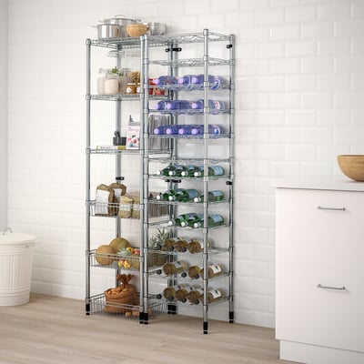 Chrome wire shelving in kitchen with wine, jars, pots; next to cabinets, sink.