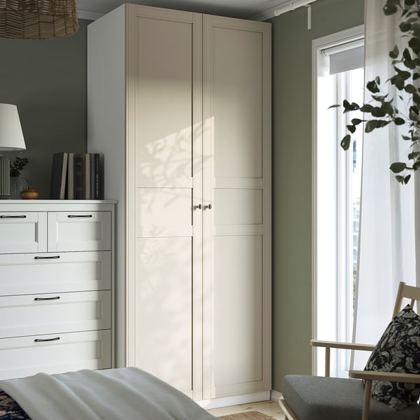 Modern bedroom with white PAX wardrobe, rocking chair & large window.