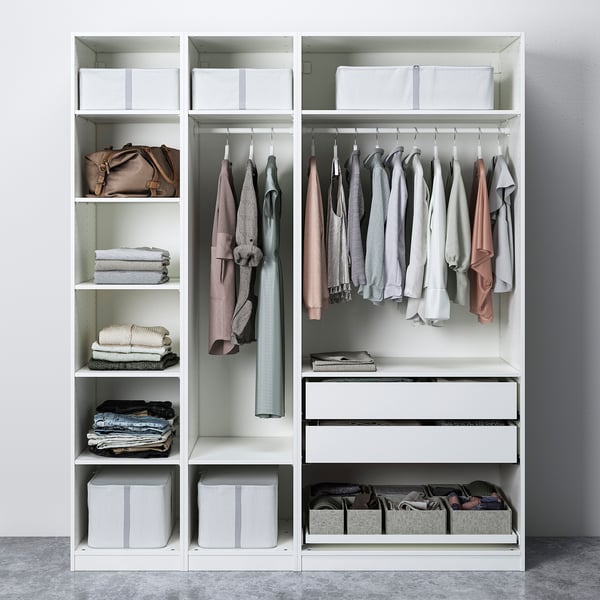 Modern wardrobe with clothes hangers, folded clothes, and storage boxes.