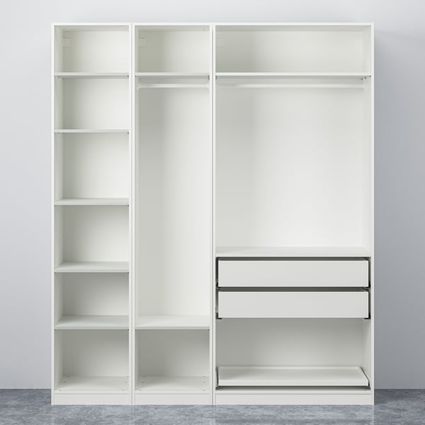 White PAX wardrobe with open sections, adjustable shelves, and black metal drawer runners, against a grey wall.