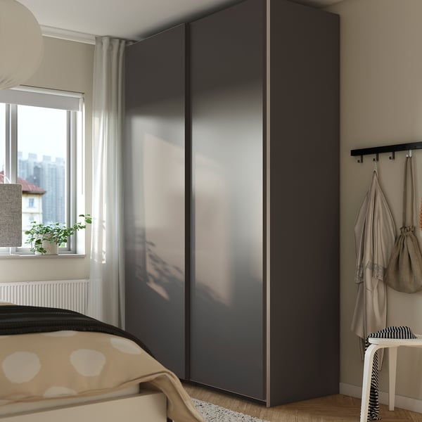 Modern bedroom with PAX wardrobe, hooks for coats, plant, polka-dot bed.