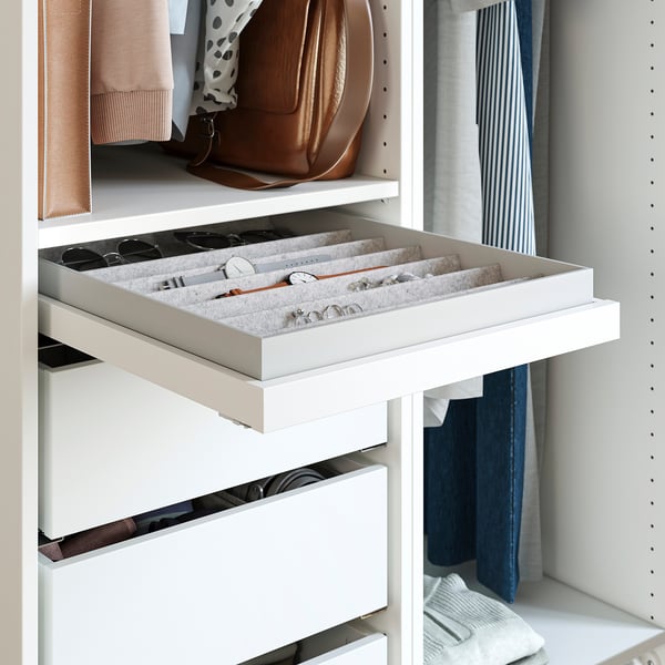 Open white PAX wardrobe drawer, showing felt-lined jewellery and watch storage.