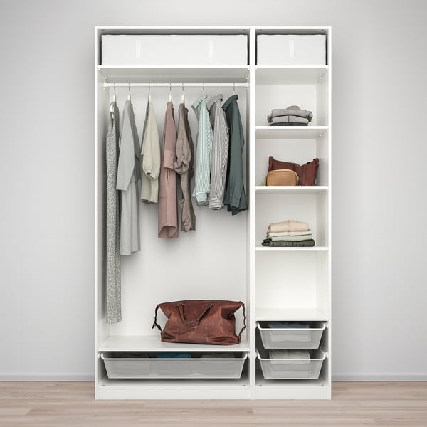 White PAX wardrobe with clothes on hangers, folded clothes, and storage baskets.
