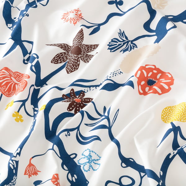 Floral sheet set, vibrant colours on white, intricate flower patterns, smooth cotton-lyocell texture, high-quality design.