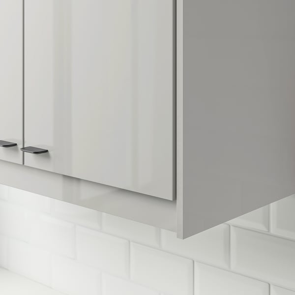 Modern grey high-gloss cabinet fronts with sleek handles, reflecting light, adding spacious feel to minimalist kitchen.