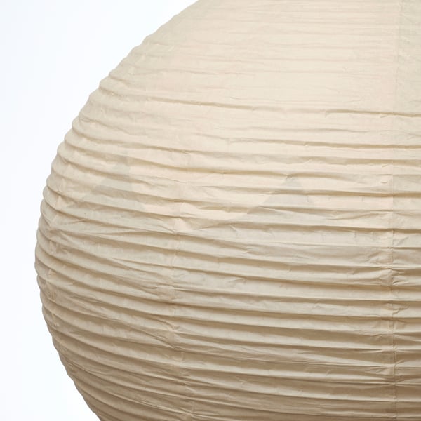 Close-up of a stylish paper lamp with a natural, textured finish, featuring horizontal layers of rice paper.