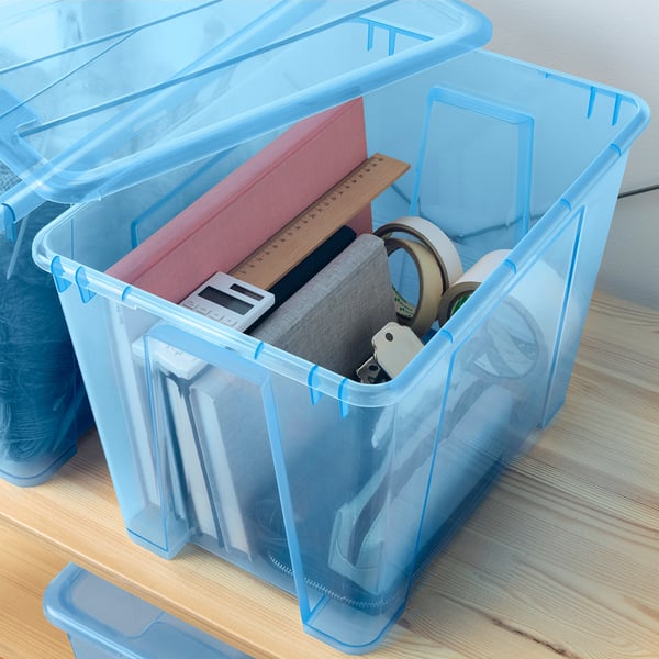 Blue SAMLA boxes with clear lids, stacked showing items like ruler, tape, and keys.