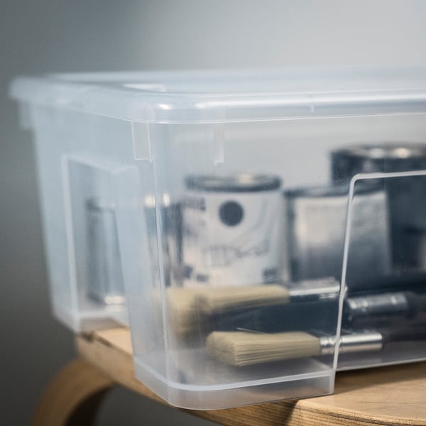 Transparent plastic container with a secure lid, storing items neatly. Durable and stackable, ideal for organising tools or supplies.