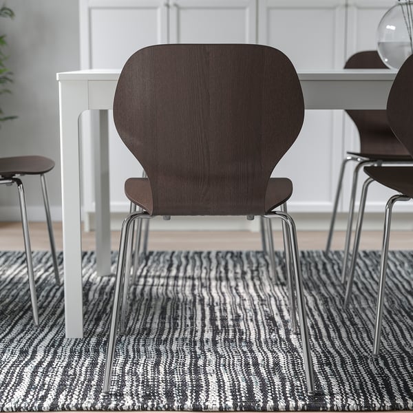 Comfortable, stackable, adjustable chair for home use on rug.