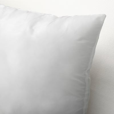 Clean, plush pillow on a white bed, showcasing its plump, inviting comfort.