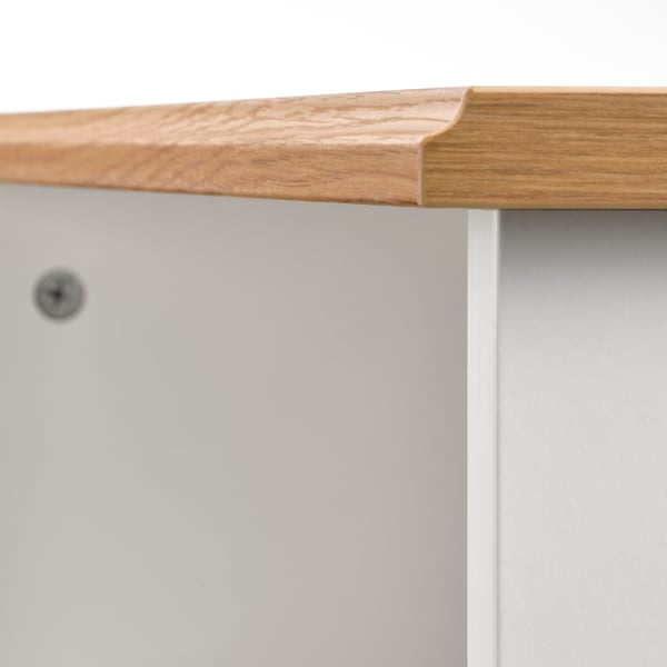 Close-up of wooden table edge, showing smooth finish and craftsmanship.