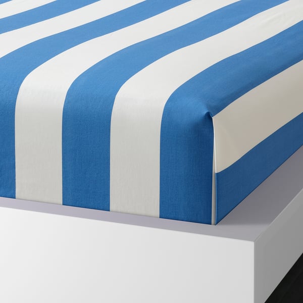 Blue and white striped bed sheet set, showcasing a flat sheet and pillowcase with envelope closure, neatly displayed on a white bed.