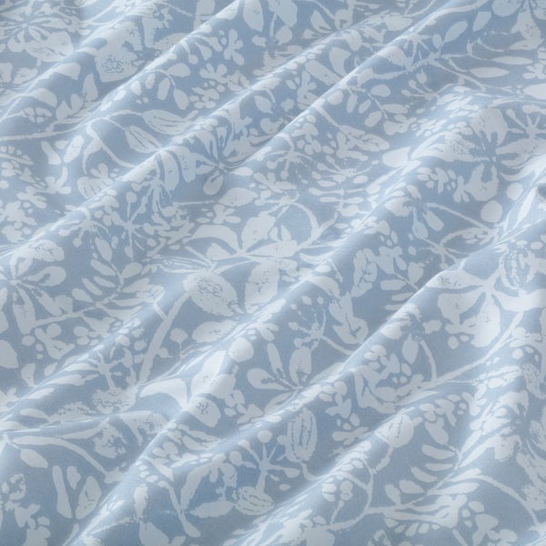 Delicate blue floral sheet, soft cotton blend, wrinkled texture, crisp design.