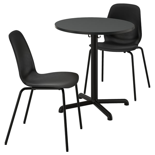 Black dining set: round metal table, stackable chairs with plastic seats.