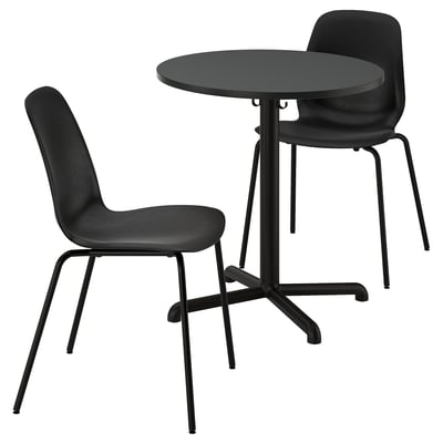 Black dining set: round metal table, stackable chairs with plastic seats.