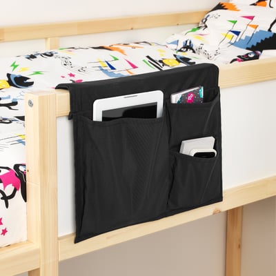 Bed pocket: hangs over bed edge, holds items like tablet, phone, and book for easy access in bed.