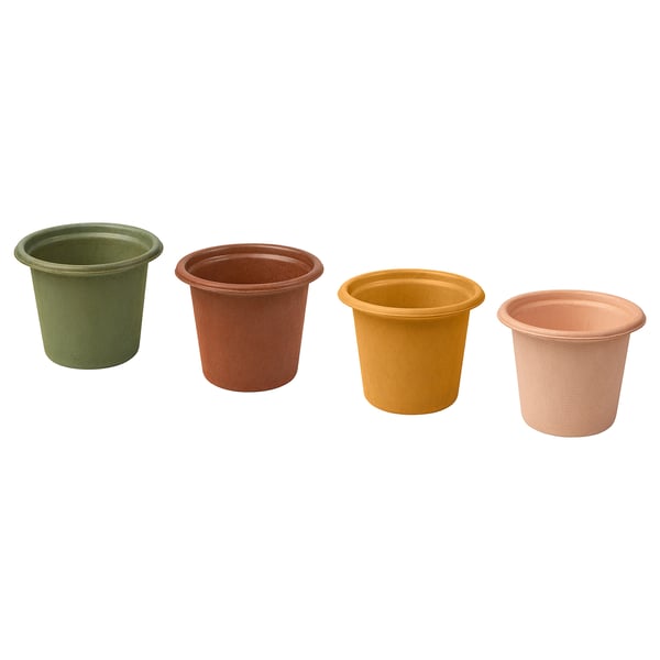 Four colourful, cylindrical plant pots in green, brown, yellow, and peach, made from recycled paper pulp.