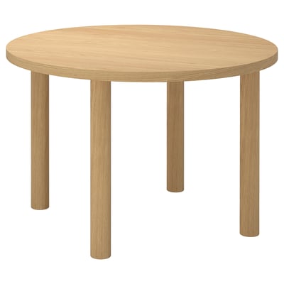 STOCKHOLM 2025 round dining table: light wood, sleek design, four legs.