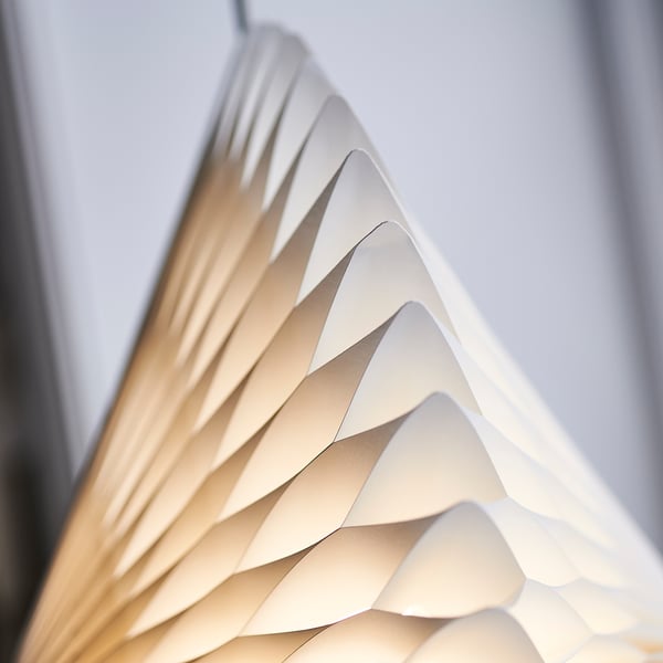 Intricate diamond-shaped lampshade, soft pleats, refined texture, elegant design.