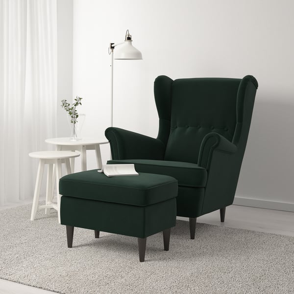 Green velvet wing chair and ottoman; cosy and stylish for comfort.