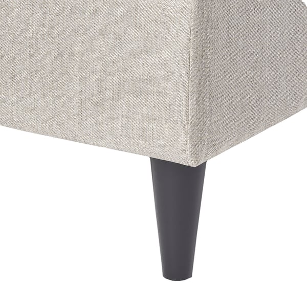 Grey upholstered ottoman with tapered black legs.