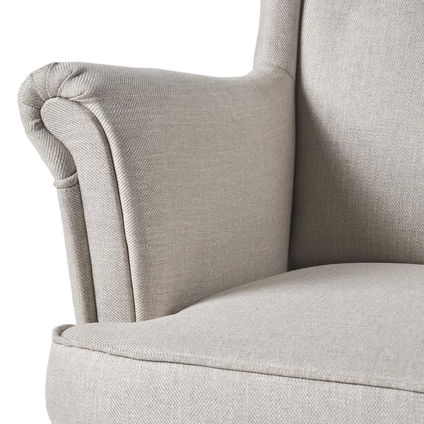 Comfy STRANDMON chair: high wing back, soft upholstery, inviting look.