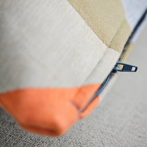 Close-up of zipped cushion cover with detailed, thick-woven texture.