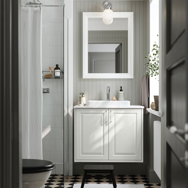 White TÄNNFORSEN vanity with mirror, sink, and window.