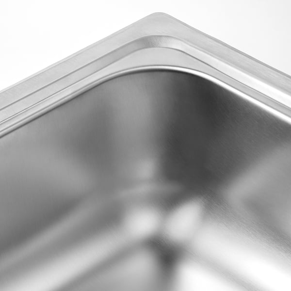 Stainless steel sink corner, smooth finish, reflecting light, sleek and durable.